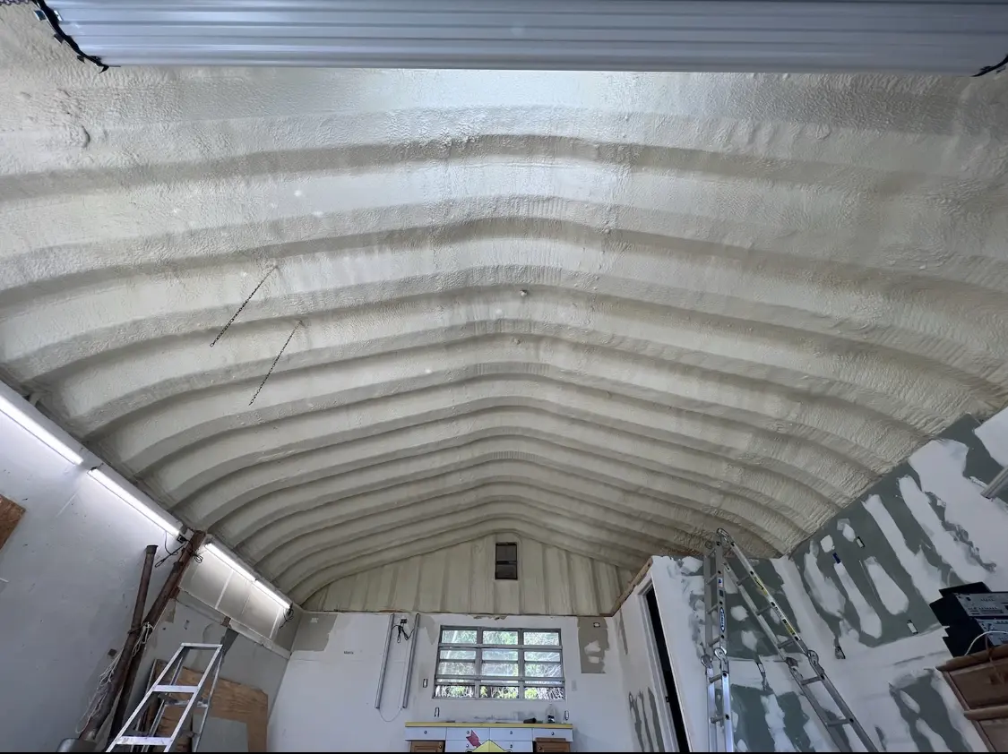 Spray polyurethane foam applied to the underside of a metal roof deck in McSwain